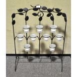 A wrought iron tea tree light holder screen,