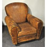 A vintage well worn leather club style armchair,