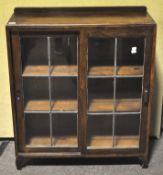 A 1940's oak and leaded glass bookcase display cabinet. Measures; 107cm x 89cm.