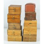 A collection of nine wooden fly fishing reel cases,