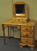 A pine dressing table/desk with a three drawer section to the right with turned legs,
