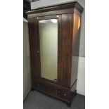 An Edwardian mahogany single, mirror door wardrobe,
