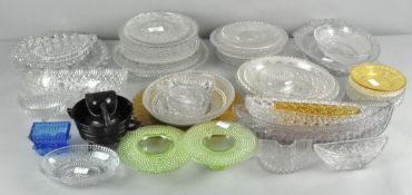 A large collection of pressed glass plates,
