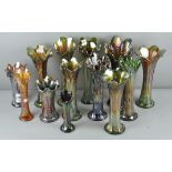 A collection of assorted green carnival glass fluted vases. Tallest; 32cm.