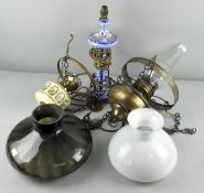 Two hanging oil lamps along with a cermic table lamp