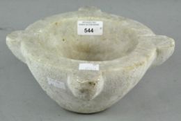 A heavy marble pestle, having four lobed sections,