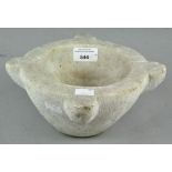 A heavy marble pestle, having four lobed sections,