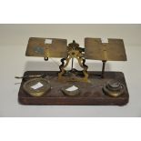 A vintage set of brass letter scales, complete with weights,
