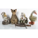 A collection of four small garden ornaments in the forms of a goose, cat and dogs.