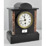 A late 19th century slate and marble mantel clock, the dial with Roman numerals denoting hours,
