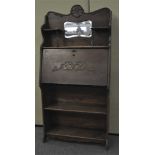 An early 20th century oak student's Bureau with mirrored back, fall front door with fitted interior,