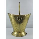 An early 20th century Arts & Crafts Brass coal bucket with swing handle to top with tapered base,
