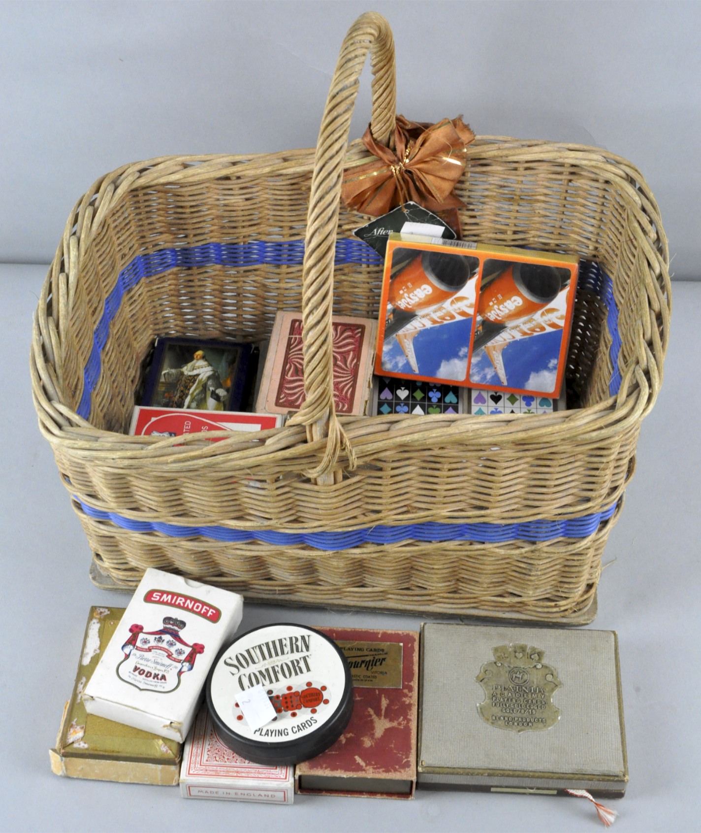 A collection of assorted playing cards in a wicker basket