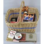 A collection of assorted playing cards in a wicker basket