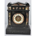 A slate and marble mantel clock having Arabic enamel chapter ring and pointed pediment atop.