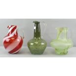 Three Studio glass water jugs, to include : Clouded, candy cane swirl and bubble control designs,