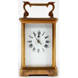 A French brass carriage clock, the enamelled dial on a brass, eight day movement,