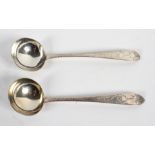 A pair of Irish silver sauce ladles, with round bowls on navette shaped handles,