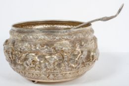 An Asian white metal punch bowl, heavily repousse and chased,