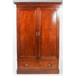 A Victorian mahogany wardrobe, circa 1880, with moulded cornice above two panelled doors,