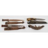 A pair of carved Tribal wooden daggers, 30 cm long; together with a hunting knife in sheath,