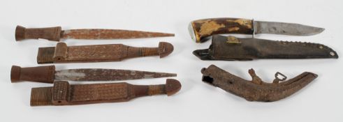 A pair of carved Tribal wooden daggers, 30 cm long; together with a hunting knife in sheath,