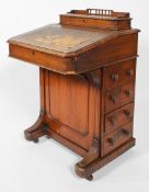 A Victorian oak davenport, the top opening to reveal stationery compartments,