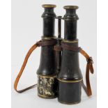 A pair of World War I period leather mounted painted brass binoculars, with leather strap,