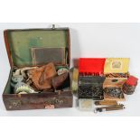 A large box and a leather suitcase containing fishing related equipment,