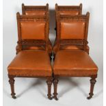 A set of four walnut Victorian Gothic style dining chairs,