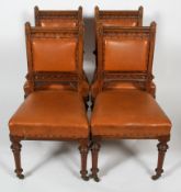 A set of four walnut Victorian Gothic style dining chairs,