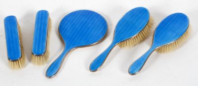 A five piece silver dressing table set with inlaid blue guilloche enamel decoration,