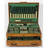 An Art Deco style oak cased, silver plated canteen of cutlery for Geo Wostenhlm,