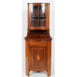 A Regency style mahogany corner cabinet, inlaid cross banding and shell decoration, with glazed top,