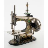 An early 20th century miniature sewing machine marked "made in Germany" underneath an Eagle