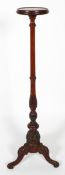 A Victorian style mahogany torchere stand, the circular tray on a carved column and tripod base,