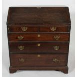 A George III oak bureau, the fitted interior above two short and three graduated long drawers,