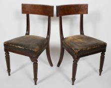 A pair of William IV walnut dining chairs, with bar back, stuffed over seat and reeded legs,