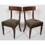 A pair of William IV walnut dining chairs, with bar back, stuffed over seat and reeded legs,