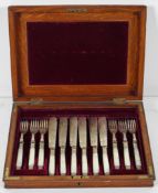 An oak case of silver plate and mother of pearl handled fish cutlery