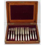 An oak case of silver plate and mother of pearl handled fish cutlery