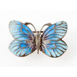 A white metal butterfly brooch having blue enamelled finish.