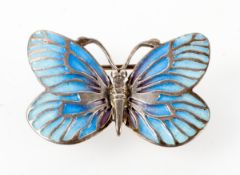 A white metal butterfly brooch having blue enamelled finish.