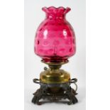 A Victorian converted oil lamp, with cast metal pierced rocaille base, with brass reservoir,