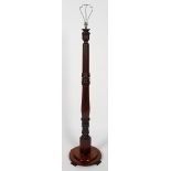A mahogany bed post standard lamp, with foliate carving,