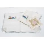 A collection of early to mid 20th century embroidered linen place mats,