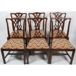 Six George III style mahogany dining chairs, each with carved interlocking pierced splat,