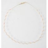 A yellow metal wire collar necklace having inter spaced pairs of freshwater pearls. Trigger clasp.