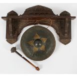An Anglo Indian wall hung gong, late 19th century, the carved hanging shelf with fruiting vine,