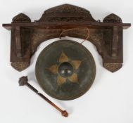 An Anglo Indian wall hung gong, late 19th century, the carved hanging shelf with fruiting vine,